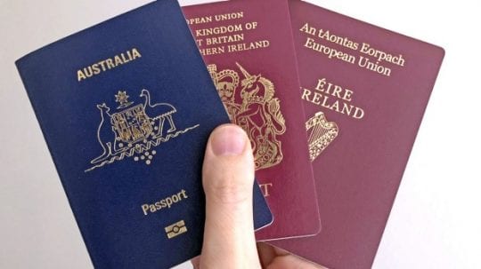 dual citizenship hand holding multiple passports