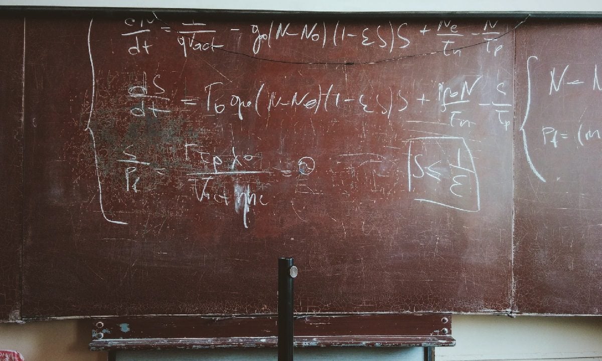 Equations written on brown-board