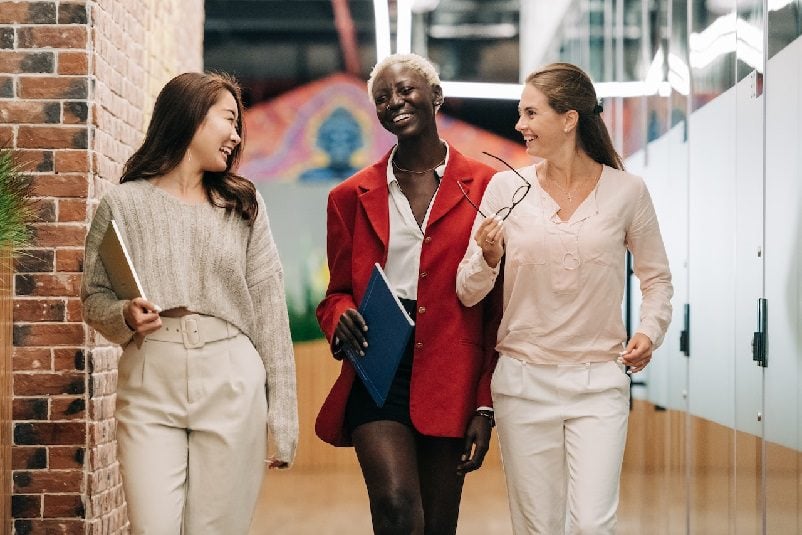 Businesswomen smiling and walking together
